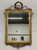 VINTAGE GILT FRAMED BEVELLED EDGE MIRROR - having a ribbon and garland crest and leaf swag apron,