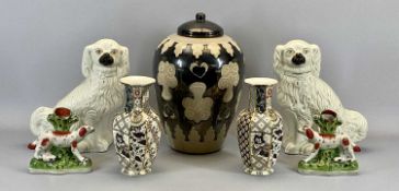 STAFFORDSHIRE SPANIELS, A PAIR - late 19th century, cream glazed with moulded fur and black muzzles,