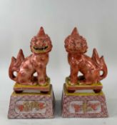 PAIR JAPANESE KUTANI PORCELAIN MODELS OF KARASHISHI, Meiji/Taisho Period, seated on tapering plinths