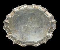 LATE VICTORIAN SILVER SALVER, pie crust edge, raised on three hoof feet, engraved 'Presented by