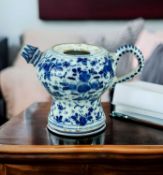 18TH CENTURY DUTCH DELFT SPOUTED POT, painted with stylised flowers allover, 11cm h Comments: