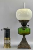 OIL LAMP - late 19th century with pierced cast iron base, circular green glass reservoir, twin