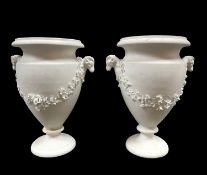 PAIR OF SWANSEA BISCUIT PORCELAIN VASES circa 1817-1820, urn form raised on a circular base, the