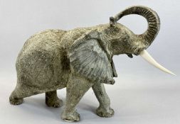 A LARGE & WELL CARVED STONE, POSSIBLY GRANITE, FIGURE OF A TRUMPETING ELEPHANT with composition