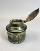 AN ART NOUVEAU 'LOETZ' STYLE IRIDESCENT GREEN GLASS INKWELL - of cylindrical form, pierced metal