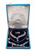 CASED WHITE METAL FILIGREE JEWELLERY SUITE, comprising brooch, necklace, bracelet and earrings