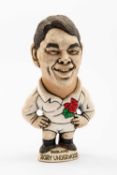 GROGG CARICATURE BY JOHN HUGHES OF RORY UNDERWOOD standing on a titled base, wearing his England