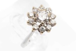 PLATINUM DIAMOND CLUSTER RING, the central stone (0.4cts approx.) surrounded by ten further diamonds