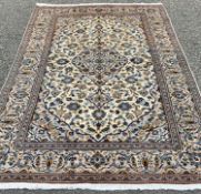 FINE KASHAN RUG, tonal cream and blue ground with extensive floral patterning and motifs to the
