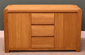 ULTRAMODERN LIGHT OAK SIDEBOARD, having three central opening drawers flanked by twin cupboard doors