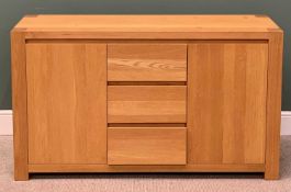 ULTRAMODERN LIGHT OAK SIDEBOARD, having three central opening drawers flanked by twin cupboard doors