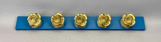CAST ROSE GILT BRASS DOOR FURNITURE (5) - mounted on a board
