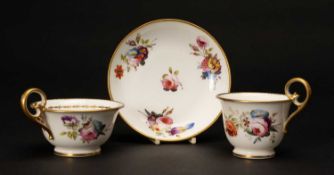NANTGARW PORCELAIN TRIO painted with sprays of summer flowers, gilt dentil rim and inside laurel