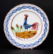 LLANELLY POTTERY COCKEREL PLATE circa 1900, continuous sponged floral border in blue, the interior