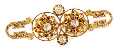 14K GOLD DIAMOND BAR BROOCH of double flowerhead design, set with old and rose cut diamonds, foliate