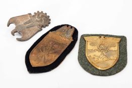 THIRD REICH PRESSED METAL BADGES, comprising Narvik campaign shield on black felt backing, 9cms h,