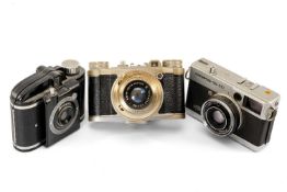 THREE VARIOUS CAMERAS, comprising Olympus 35 EC f/42mm, Beacon, Altix Trioplan 1/2.9 50mm (3)