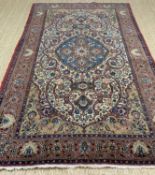 PERSIAN RUG, probably Isphahan, central royal blue palmette medallion, on a cream scrolling vine