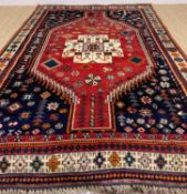 STYLISH ORIENTAL RUG, probably Kashgai/Qashqai, geometric cream medallion on madder field with
