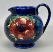 MOORCROFT 'ANEMONE' PATTERN GLOBULAR FORM JUG, on blue ground with loop handle, impressed marks