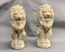 A PAIR OF RECONSTITUTED GARDEN STATUES modelled as seated lions, 50cms H