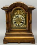WALNUT CASED MANTEL CLOCK, early 20th Century, the case with dome top, arched door flanked by reeded