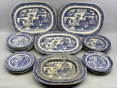BLUE & WHITE TRANSFER DECORATED WILLOW PATTERN PLATES, A COLLECTION, including 4 x large oval meat