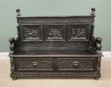 ANTIQUE STAINED OAK JACOBEAN-STYLE BOX SEAT HALL BENCH, with carved lion arms, tavern interior