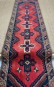 TURKISH RUNNER, red and blue cruciform medallions on madder field, navy blue spandrels, shanked