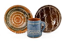 THREE EWENNY POTTERY ITEMS, comprising two cawl bowls, 20cms diam. and a cider tankard, 12cms h, all