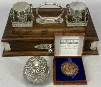 EPNS MOUNTED OAK TWO BOTTLE DESK STAND, an embossed silver top cut glass jar and a boxed Home