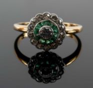 YELLOW METAL DIAMOND & EMERALD HALO RING, the shank engraved with initials and date '11.7.11',