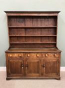 GEORGE IV NORTH WALES OAK DRESSER having a wide border three-shelf rack on a peg joined construction
