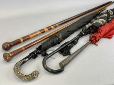 TWO MIXED WOOD WALKING CANES & THREE VINTAGE BROLLIES, one with white metal handle, having all