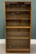 NARROW TEAK & GLASS LIBRARY BOOKCASE by Frederick Restall, Birmingham, having four sliding front