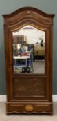 LATE 19TH CENTURY FRENCH WALNUT ARMOIRE having a shaped arched top cornice over a single bevel edged