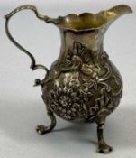 GEORGE II SILVER CREAM JUG of baluster form, with acanthus capped scrolled loop handle, floral and