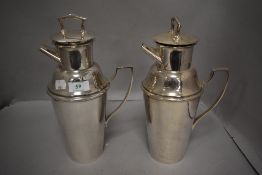 Two iconic 1930s silver plated Asprey of London milk churn shaped cocktail shakers having handle
