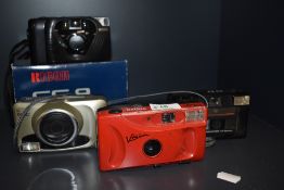 Four cameras. A fujifilm zoom date 90, a Halina Vision 400, a Kodak 35EF, and a boxed Ricoh FF9