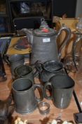 A selection of pewter wares including Tankards, twin handle vase and a very large water jug by The