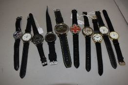 Ten mens watches all having black straps.