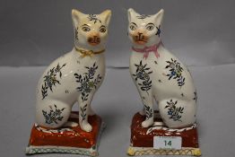 A pair of Wemyss style cat studies, having foliate patterns with ribbons tied round necks.