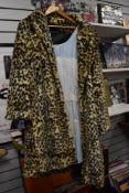 A ladies faux fur coat, size 24.