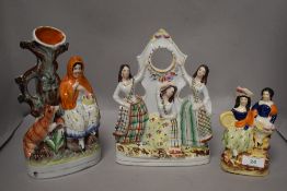 Three Staffordshire flat back figurines, to include little red riding hood and three ladies in