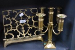 A brass book rest and a candlestick.