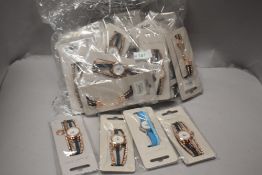 A bag full of ladies fashion watches new in packaging.