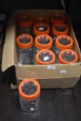A box of traditional Kilner jars with screw tops in two sizes.