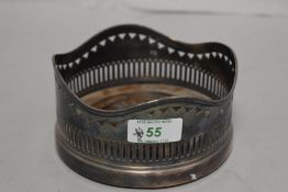 A silver plated wine coaster, of traditional form with turned oak interior, 12.5cm