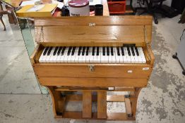 An early 20th century portable R.F Stevens preachers organ with a golden oak case
