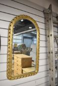 A gilt frame wall mirror